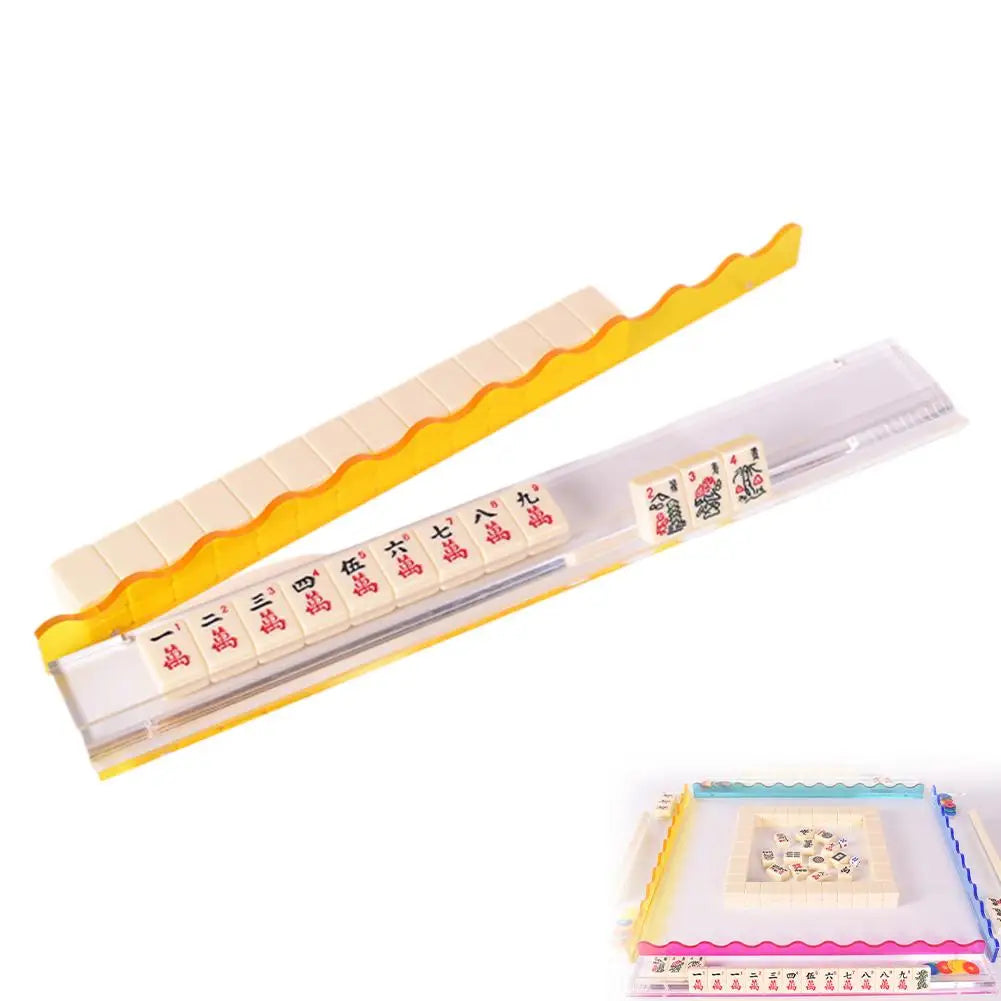 Sunny yellow Aspen rack: the wavy yellow pusher rests on a wall of tiles while the clear base holds a row of craks