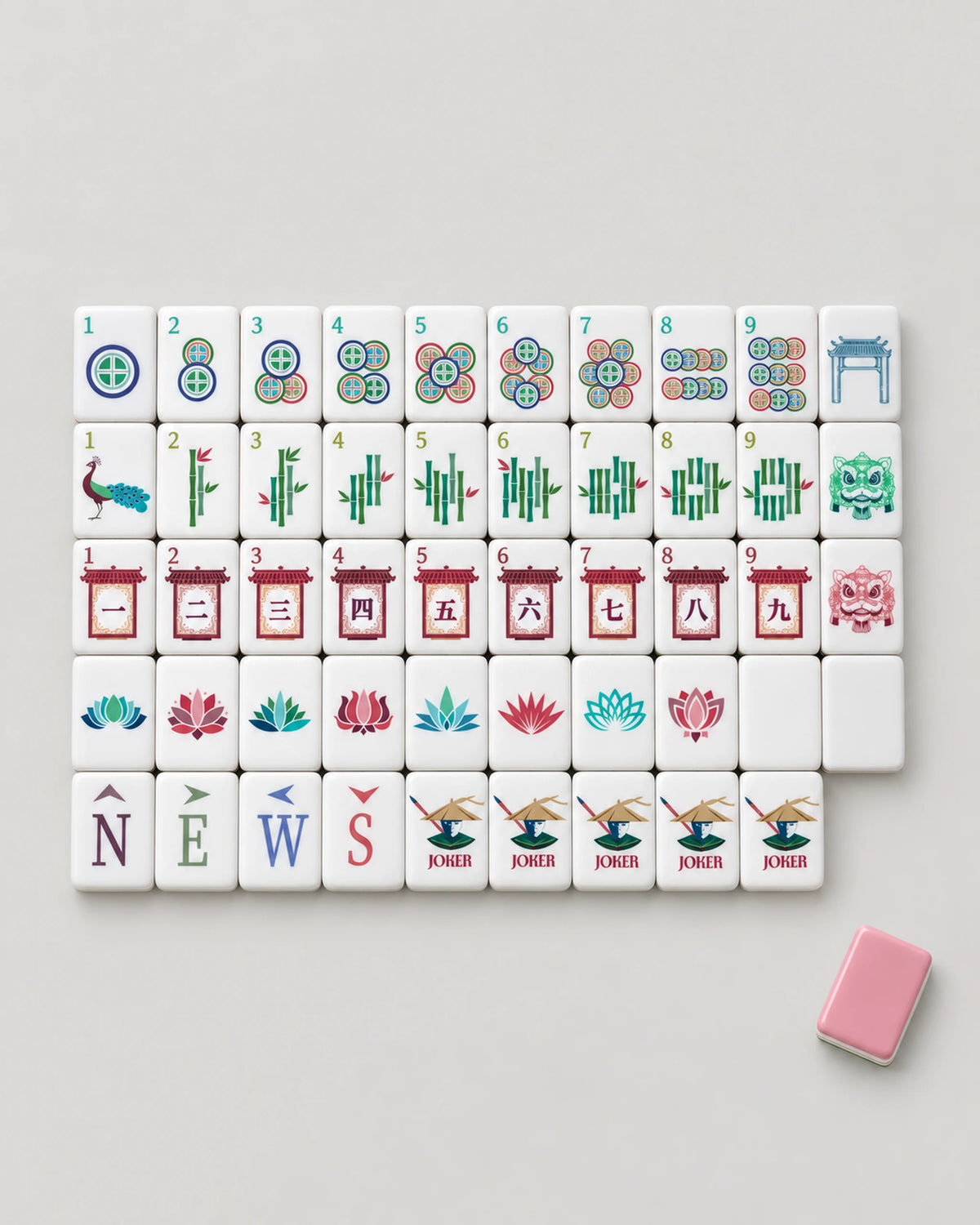 Pink mahjong set laid out by suit: coin dots, peacock bamboo, pagoda characters, lotus flowers, winds and Jokers