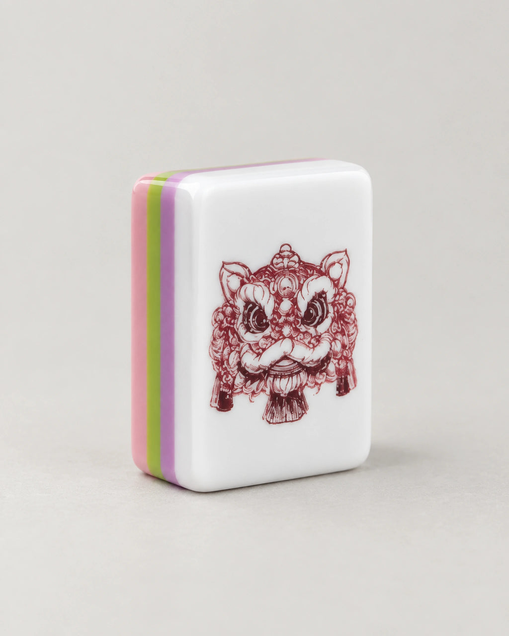 Close-up of a Begonia dragon tile with a red lion dance head, edges in pink, green and purple layers