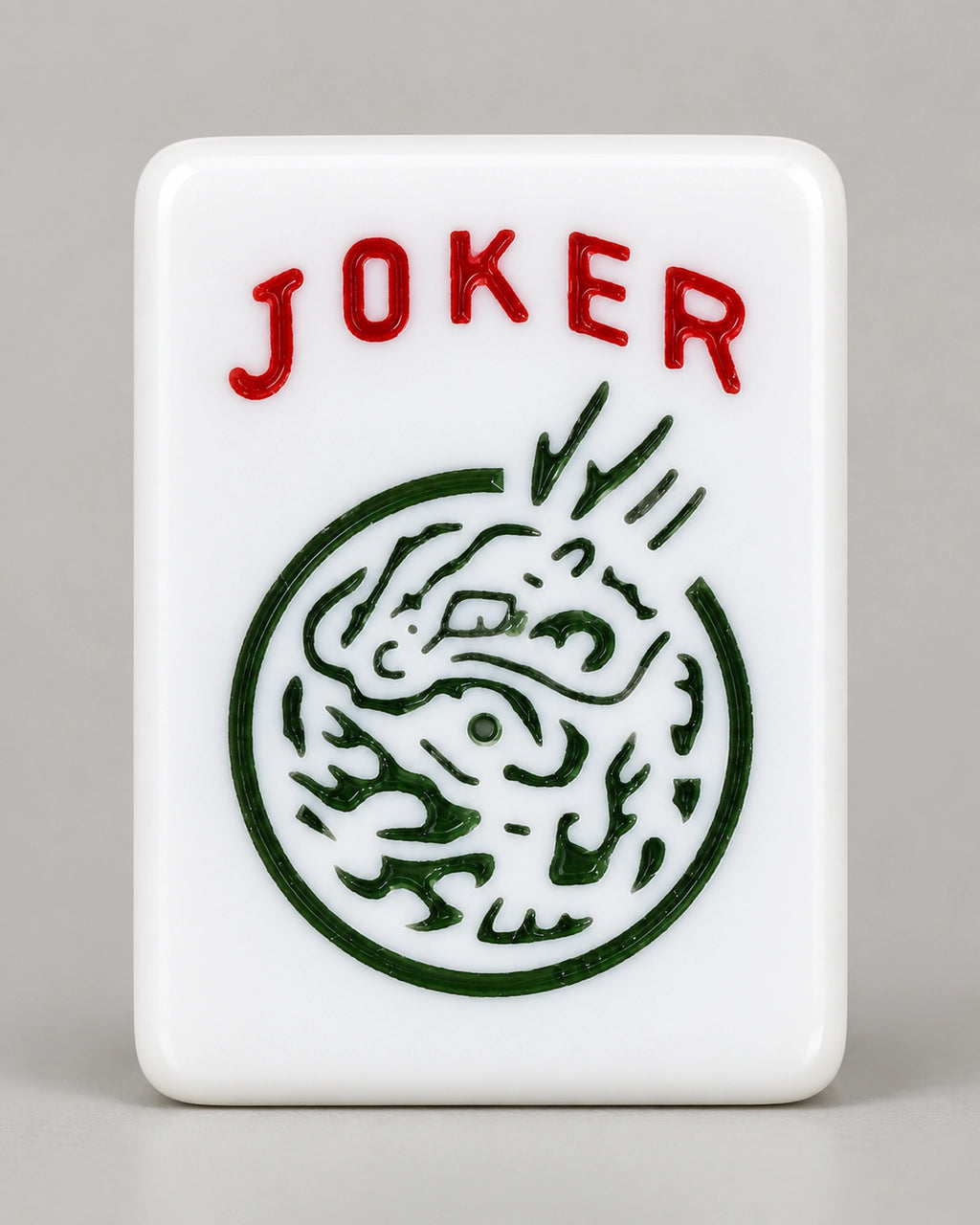 Close-up of a white Bluebell joker tile with JOKER in red letters above a round green medallion
