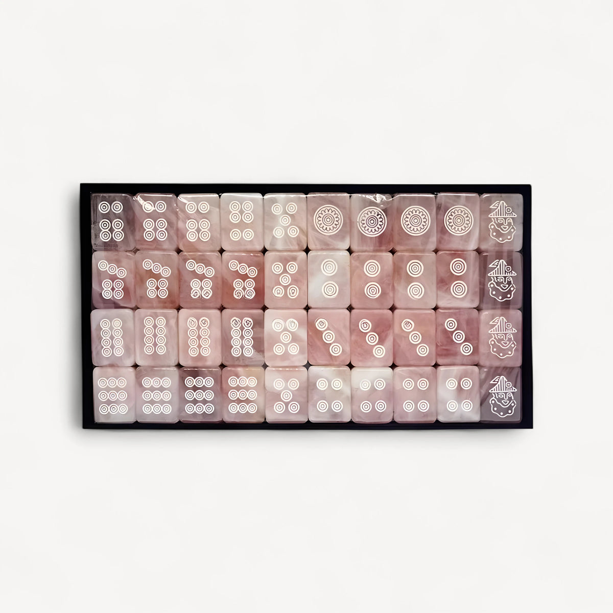 Tray of Celadon dot tiles, white engraved circles on pink faces, with figure tiles in the last column
