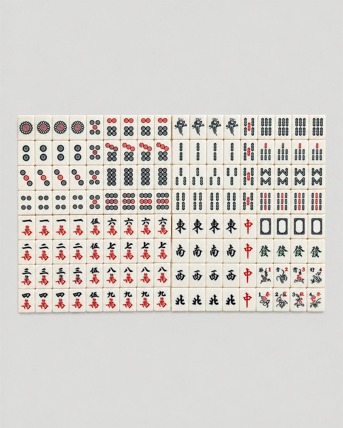 All 144 Chestnut tiles lined up in eight rows on a gray surface, ivory faces with red, green and black marks