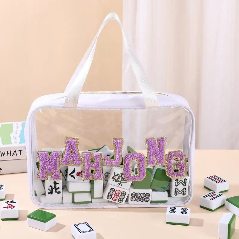 Coir with white trim and handles, lilac chenille letters and white and green tiles visible inside