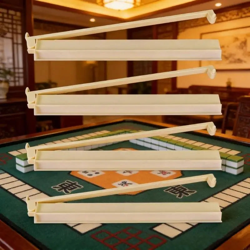 Four cream Larch racks with pusher arms raised, in front of a game table set with green tiles