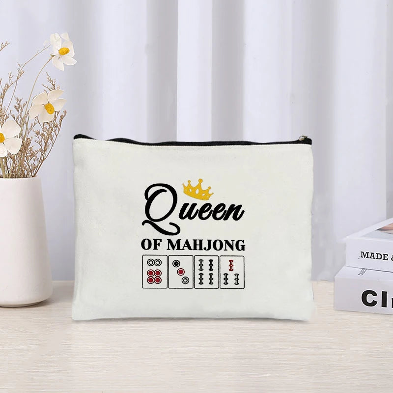 Linen pouch with a gold crown and Queen of Mahjong in black script above five dot and bamboo tiles
