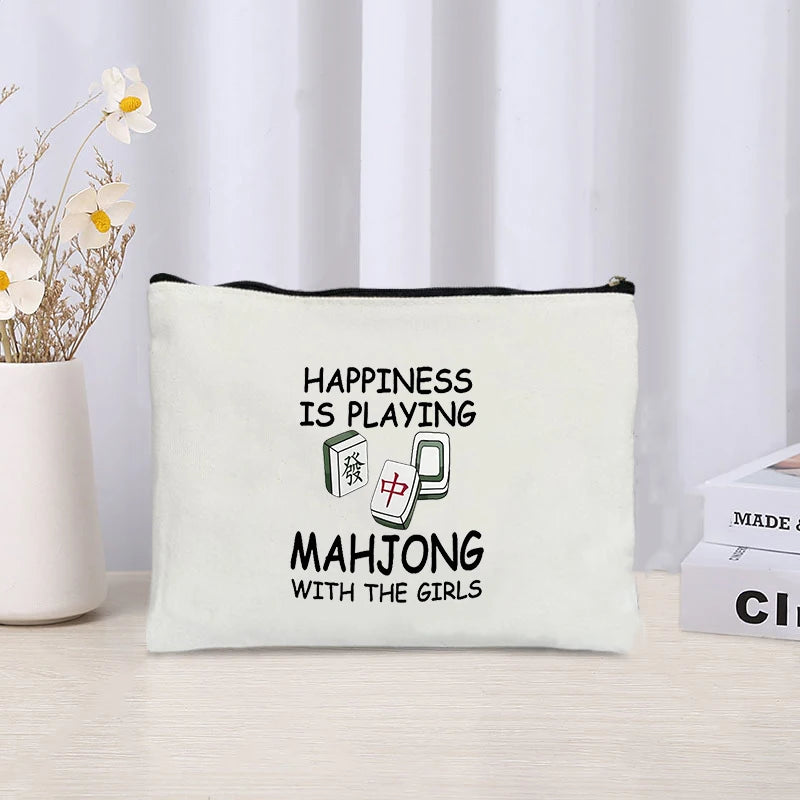 Linen pouch printed Happiness Is Playing Mahjong With the Girls in block letters beside two tiles