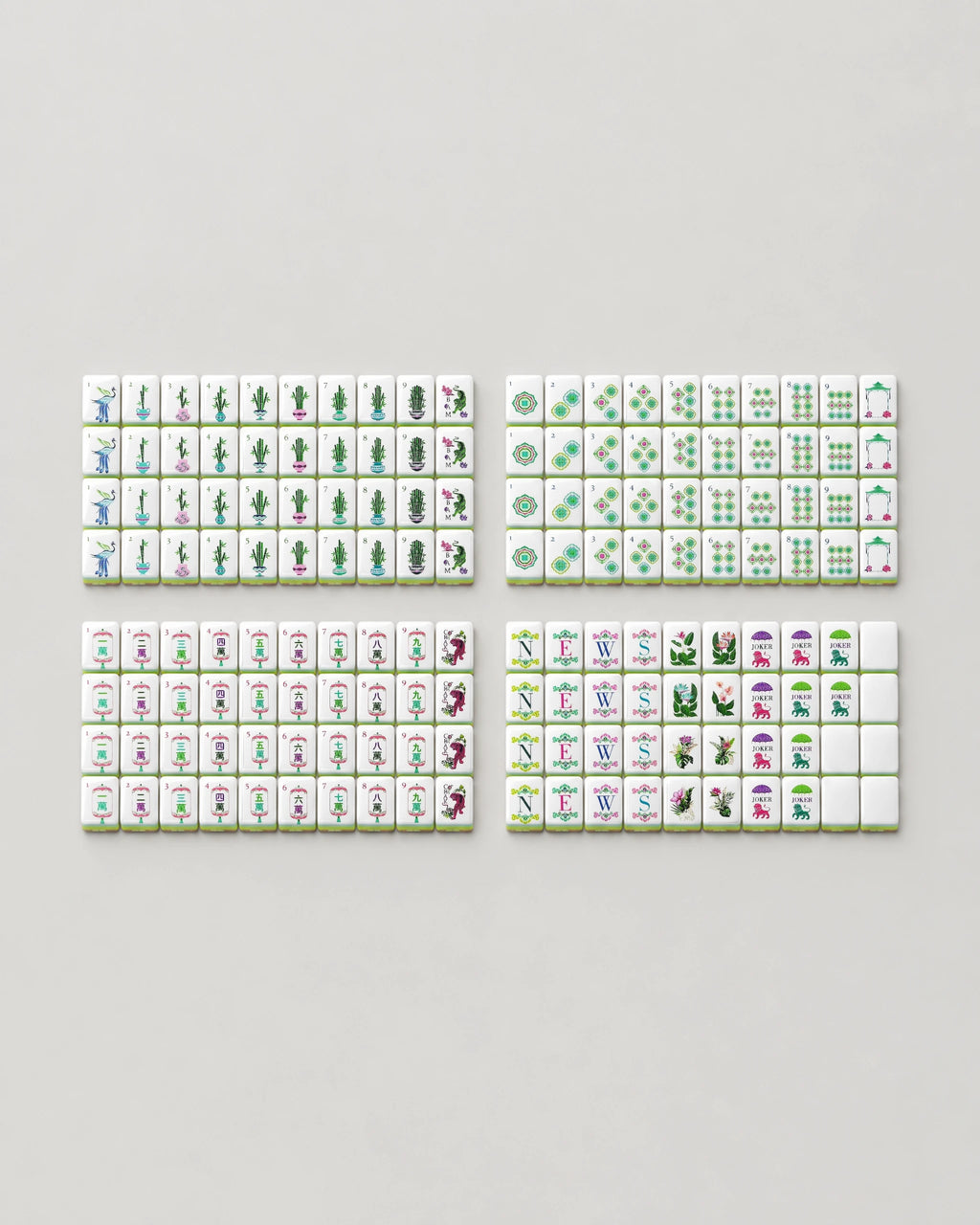 The complete Monstera set of 160 bamboo mahjong tiles for American Mahjong laid out face up: dots, bams, craks, winds, dragons, 8 tropical flowers, 10 jokers and 6 blanks