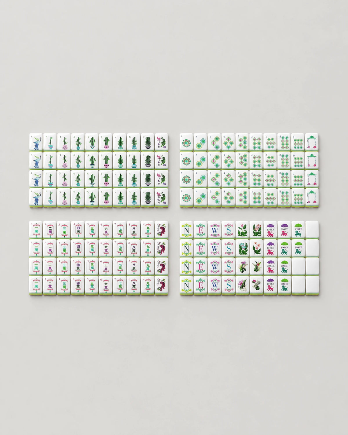 The complete Monstera set of 160 bamboo mahjong tiles for American Mahjong laid out face up: dots, bams, craks, winds, dragons, 8 tropical flowers, 10 jokers and 6 blanks