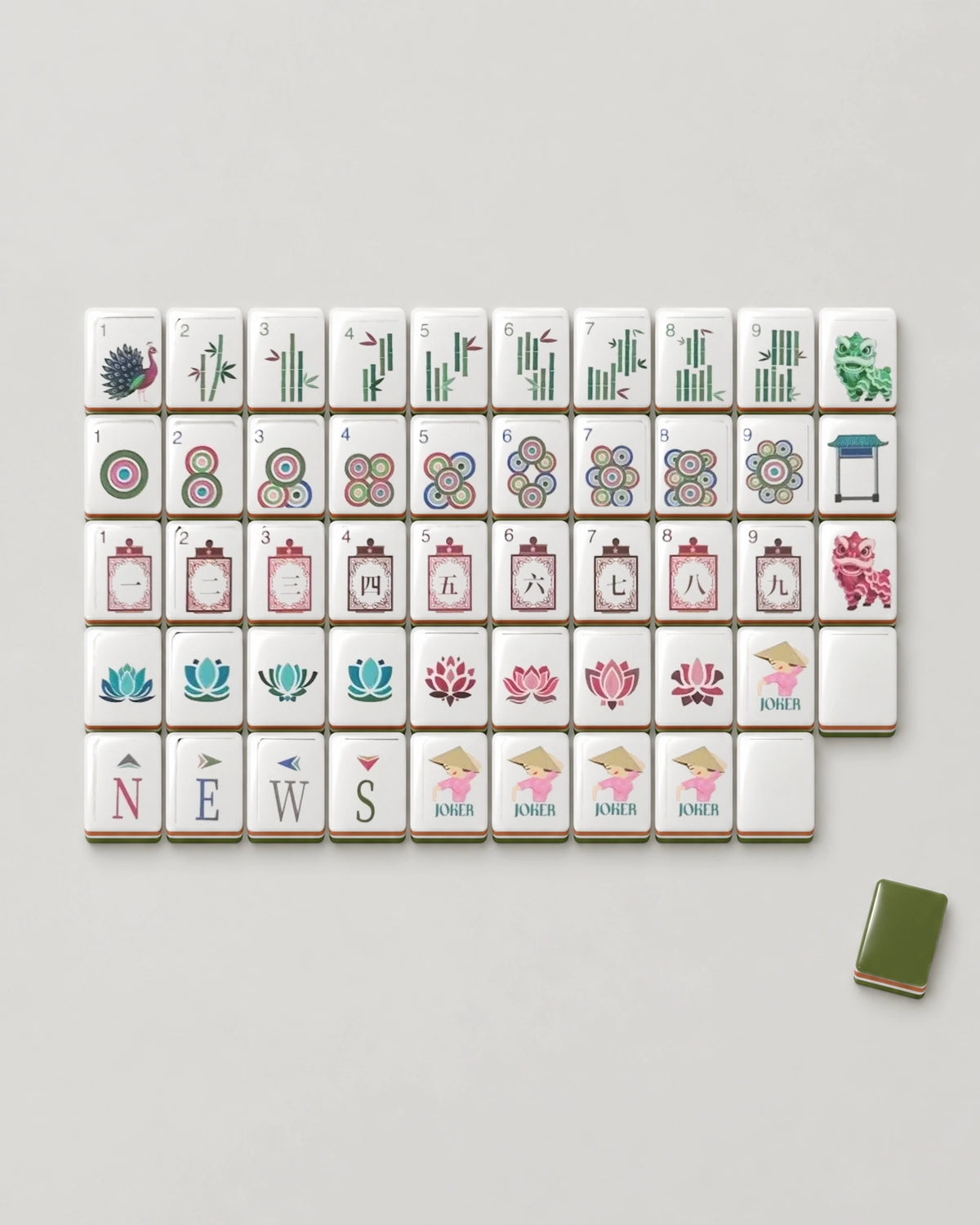 Olivine olive green mahjong tiles laid out face up, showing every dot, bam, crak, wind, lion dance dragon, lotus flower, joker and blank design beside one olive green tile back
