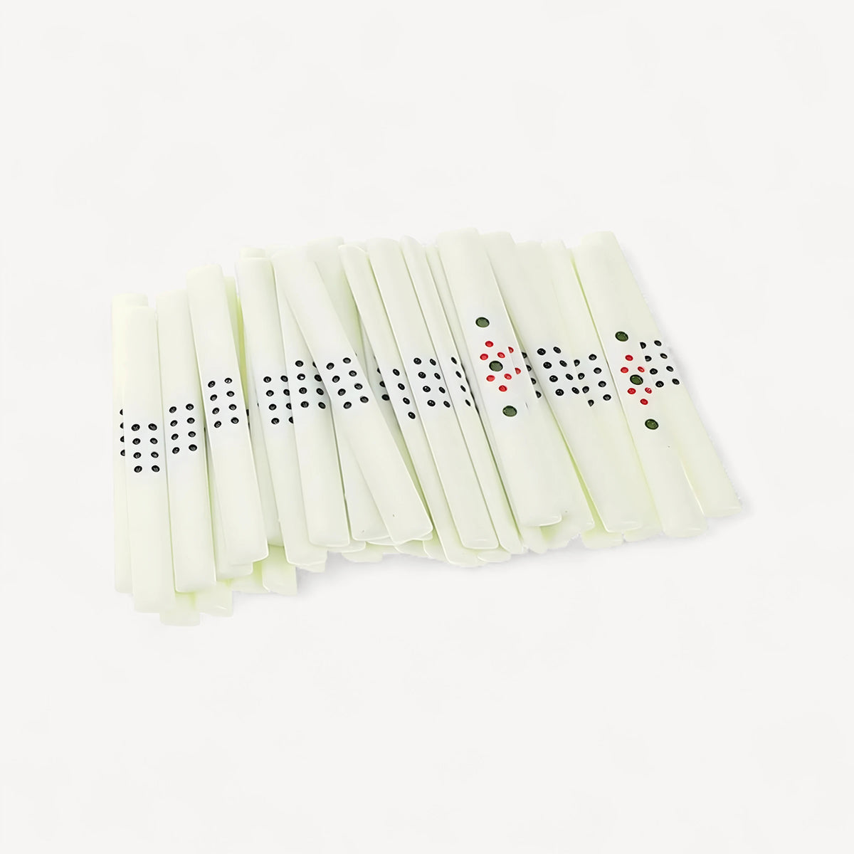 Mahjong sticks with black dots: a fanned pile of ivory sticks, most with eight dots and a few with red and green