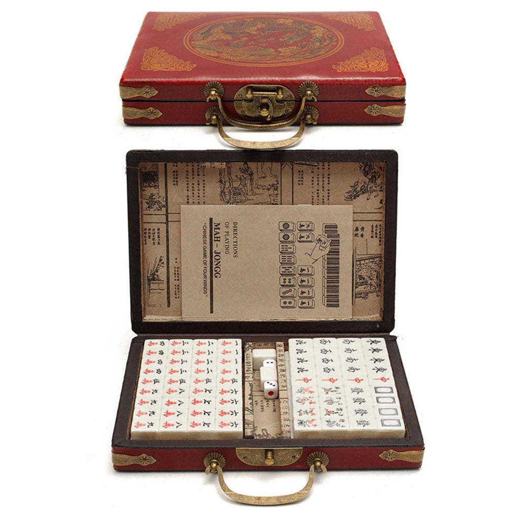 Chinese mahjong tile set in a red case with gold dragon art and a brass handle, shown closed and open with its booklet