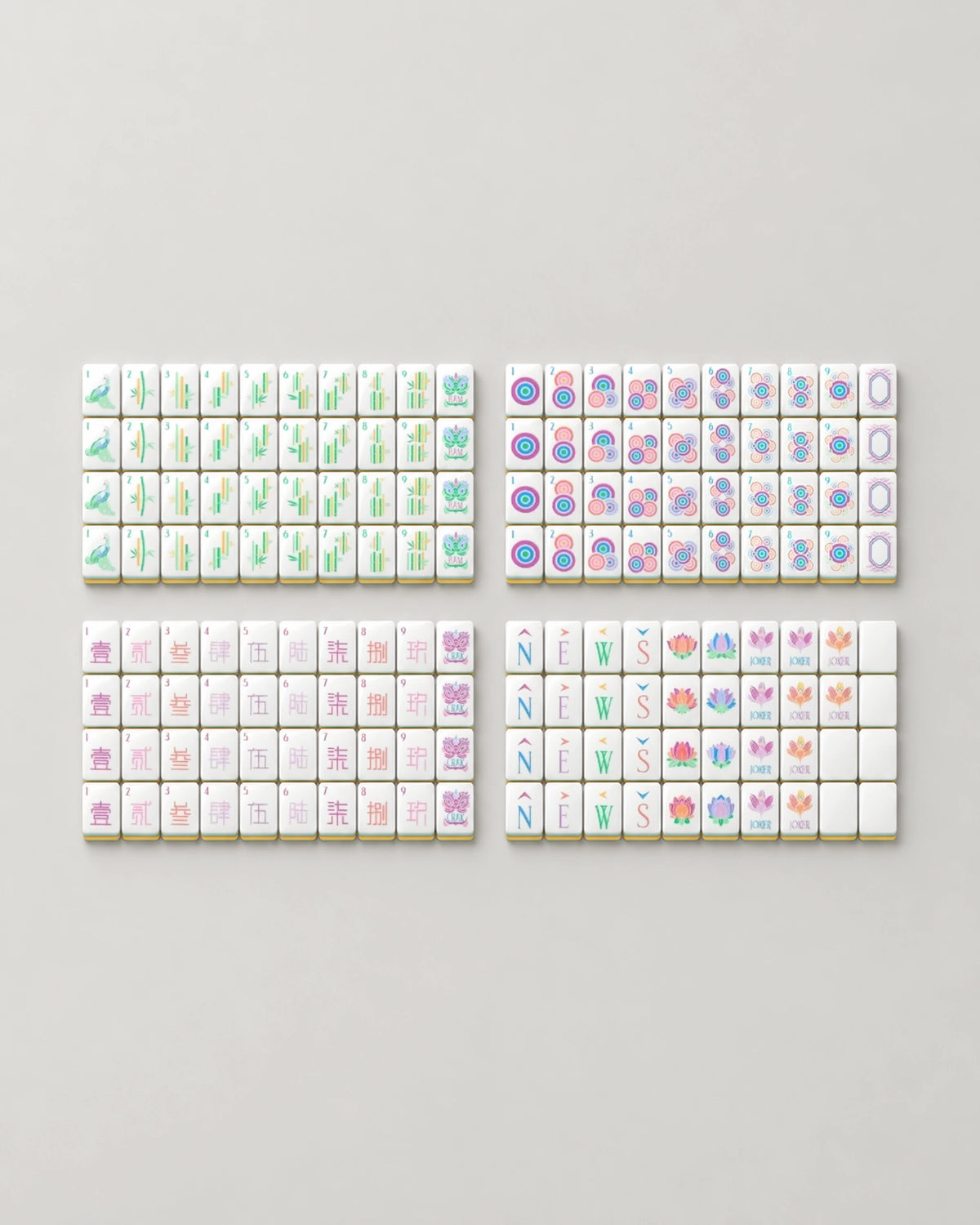 The complete Sherbet set of 160 pastel mahjong tiles for American Mahjong laid out face up: dots, bams, craks, winds, dragons, 8 lotus flowers, 10 jokers and 6 blanks
