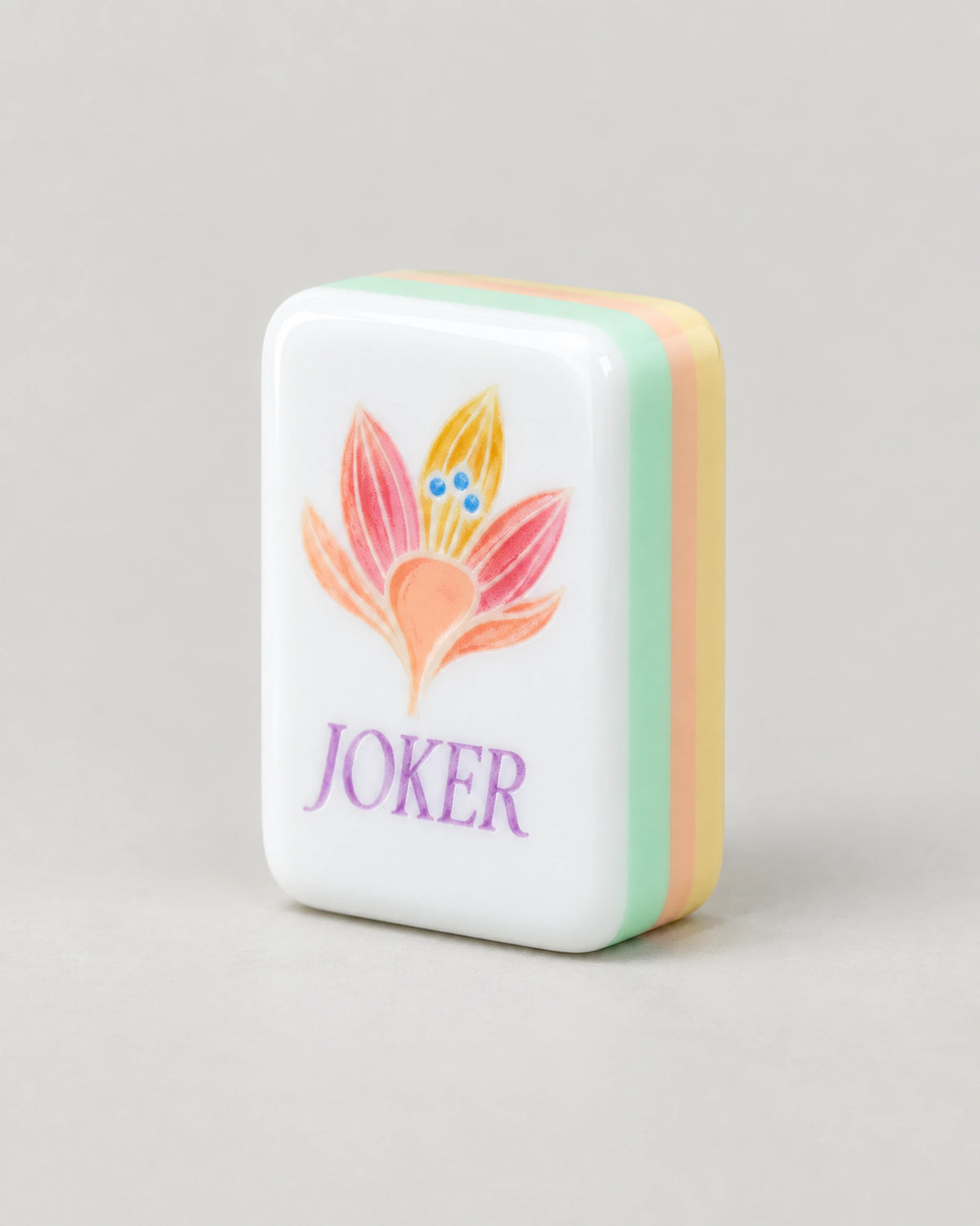 Sherbet mahjong tiles, butter yellow backs and lotus jokers, close-up of a single tile