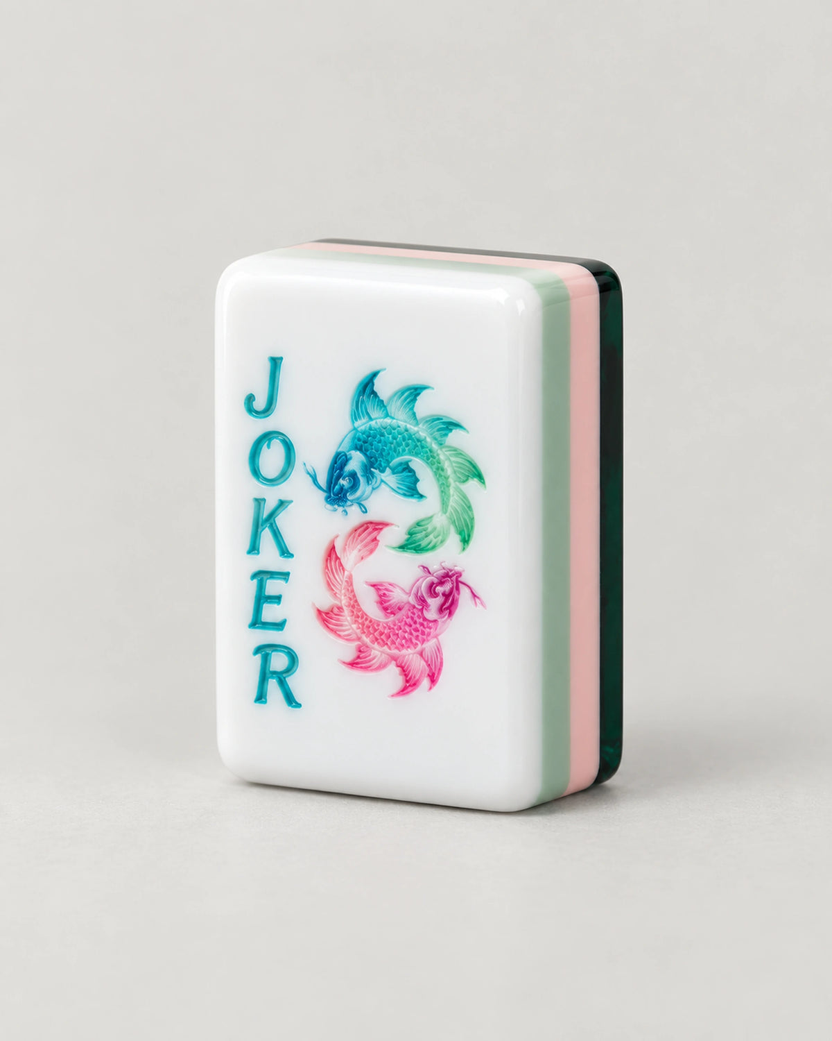 Close-up of a Strata Joker tile with teal and pink koi fish, its edges in mint, pink and dark green layers