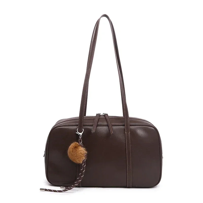 Dark coffee Teak, front view, with its two long straps and a pom-pom charm hanging at the front