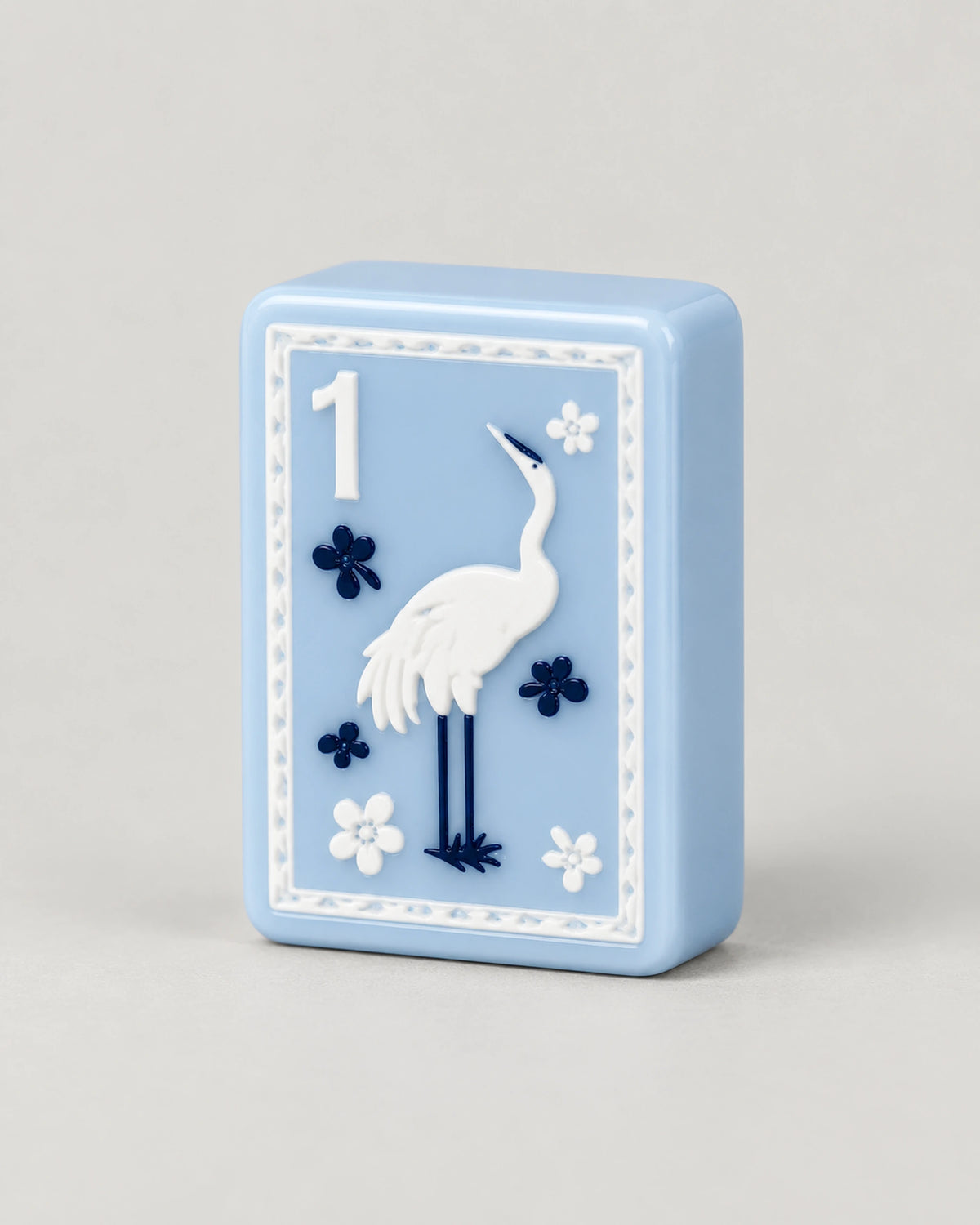 Close-up of the Willow 1 Bam tile: a white crane, navy flowers and a corner number 1 on light blue